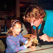 Andrew shows his niece Paige his soprano saxophone at Manno's Grill.